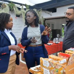 KTB CEO June Chepkemei (L) engages with an agro-tourism partner to discuss bio-organic snack products and sustainable value chains. Looking on is EatOut Africa Director Mikul Shah.