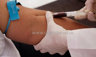 A nurse takes blood for testing from a patient/AFP