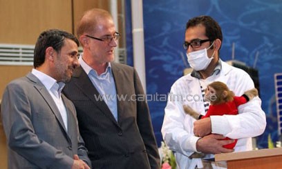 President Ahmadinejad looks at a space monkey on Iran's National Day of Space Technology in Tehran, February 4/AFP