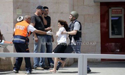 A woman hostage is evacuated by Israeli security forces in Beersheva, on May 20/AFP