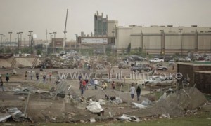 People walk near the Moore Warren Theater after a powerful tornado ripped through the area on May 20, 2013/AFP
