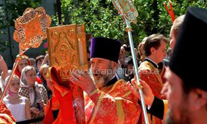 A priest holds a holy book during a service conducted by Russian Orthodox Patriarch Kirill/AFP