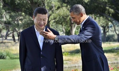 US President Barack Obama and Chinese President Xi Jinping head for their bilateral meeting at the Annenberg Retreat at Sunnylands in Rancho Mirage, California, on June 7, 2013/AFP