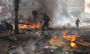 Reporters run for cover during clashes between upporters of Egypt's ousted president Mohamed Morsi, and police in Cairo/AFP