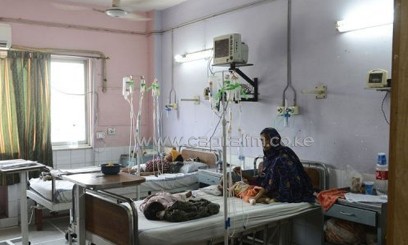 A Pakistani mother watches over children suffering from measles at a hospital in Lahore, on June 4, 2013/AFP