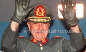 Chilean dictator Augusto Pinochet waves to the crowd during a visit to Antofagasta, on October 21, 1986/AFP