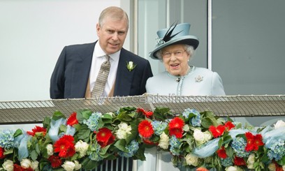 Prince Andrew, the Duke of York, speaks to Queen Elizabeth II at the Epsom Derby Festival in England on June 1, 2013/AFP