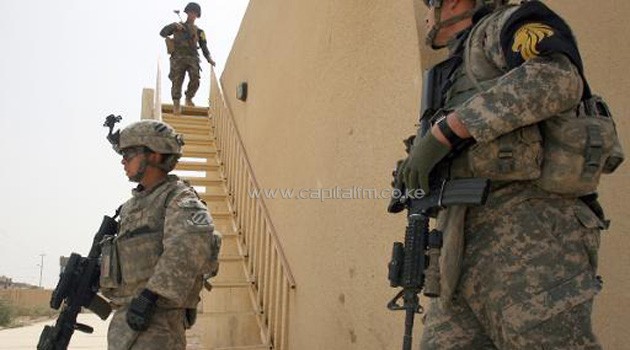 Soldiers patrol a school in Gorga Chal in northern Iraq on August 27, 2010/AFP