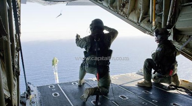 Royal Australian Air Force personnel launch a Self Locating Data Marker Buoy from a C-130J Hercules aircraft in the southern Indian Ocean as part of the Australian Defence Force's search for Malaysia Airlines flight MH370, March 20, 2014/AFP