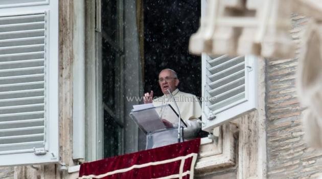 Pope Francis delivers his Sunday Angelus prayer from the window of his apartment on St. Peter's square at the Vatican on March 2, 2014/AFP