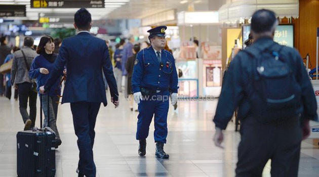 A police officer patrols the departure terminal at Haneda International Airport in Tokyo ahead of the upcoming visit of US President Barack Obama/AFP