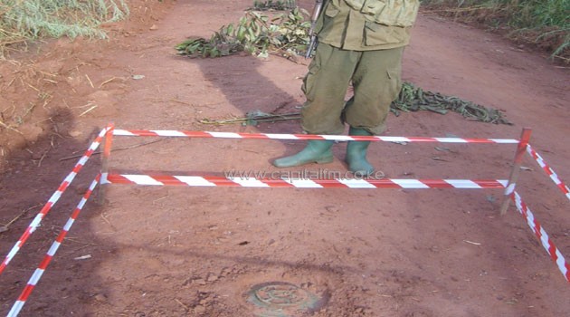 A Ugandan soldier prevents local residents in 2007 from stepping on a landmine planted by the rebel Lord's Resistance Army/XINHUA-File