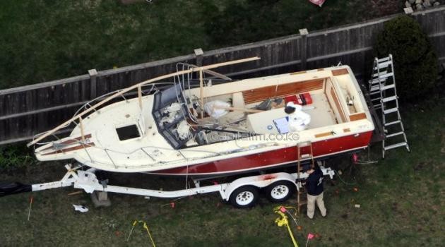 File picture shows investigators working around the boat where Boston bomb suspect Dzhokhar Tsarnaev was found hiding after a massive manhunt, April 20, 2013 in Watertown, Massachusetts/AFP