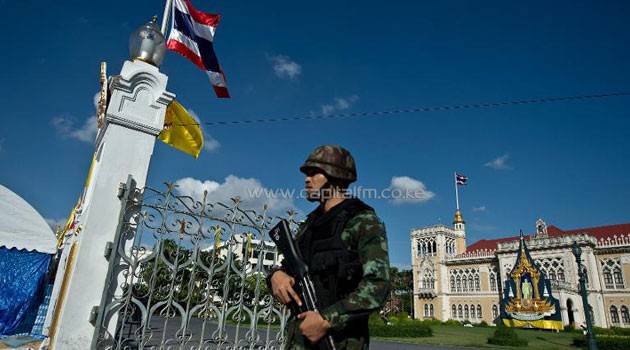 A Thai Army soldier stands guard at Government House, where the anti-government protesters had setup their main camp in Bangkok on May 23, 2014/AFP