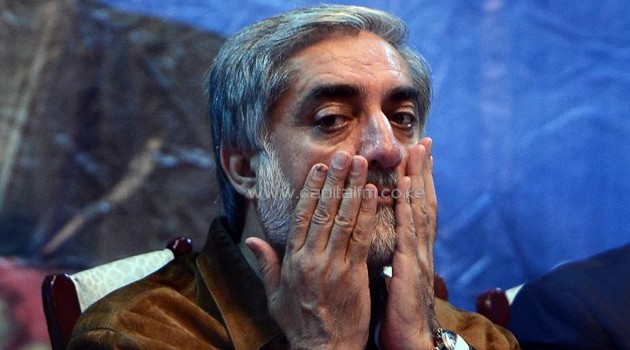 Afghan presidential candidate Abdullah Abdullah prays at an election gathering after surviving a suicide attack on his convoy in Kabul, on June 6, 2014/AFP