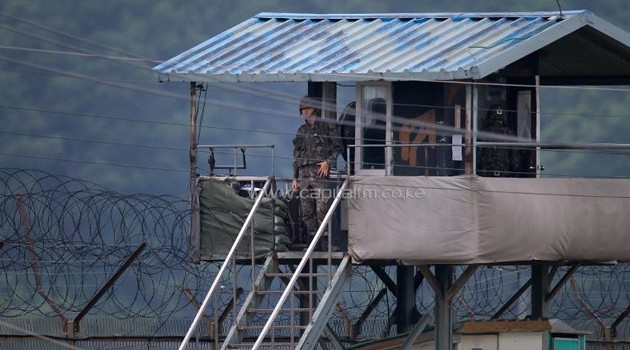 A South Korean soldier looks out from his guard post near the Demilitarized Zone (DMZ) dividing the two Koreas, June 7, 2013/AFP