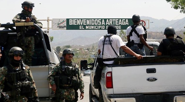 Members of the Federal Police and the Mexican Navy, patrol at the entrance of Arteaga, in the state of Michoacan, Mexico, on April 22, 2014/AFP