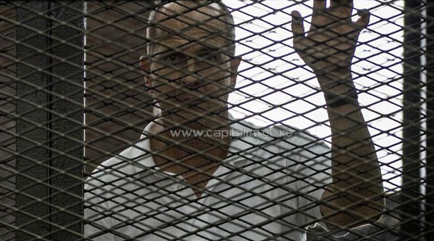 Al-Jazeera news channel's Australian journalist Peter Greste listens to the verdict inside the defendants cage during his trial/AFP