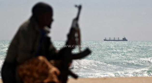 An armed pirate surveys the Somali coastline/AFP