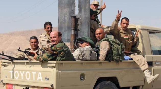 Iraqi Kurdish Peshmerga fighters celebrate on a truck near the Mosul dam after recapturing it from Islamic State jihadists on August 17, 2014/AFP