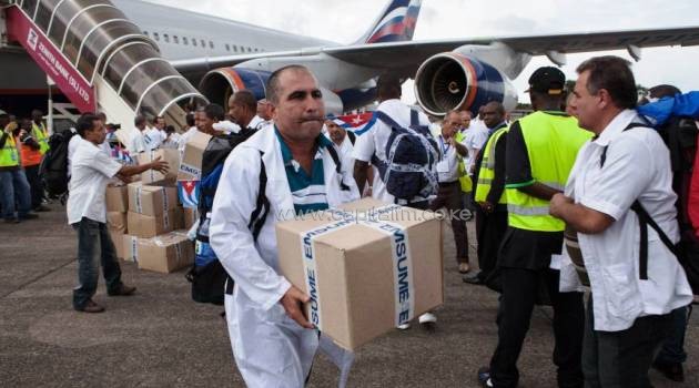 The first members of a team of 165 Cuban doctors and health workers unload boxes of medicines and medical material from a plane upon their arrival at Freetown's airport to help the fight against Ebola in Sierra Leone on Thursday/AFP