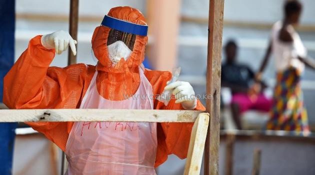 A health worker works on November 11, 2014 in the red zone of the Hastings treatment center in Hastings, outside Freetown, Sierra Leone/AFP