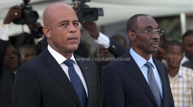 Haitian President Michel Martelly (L) stands with Prime Minister Evans Paul before a speech to the nation at the National Palace in Port-au-Prince on January 16, 2015/AFP