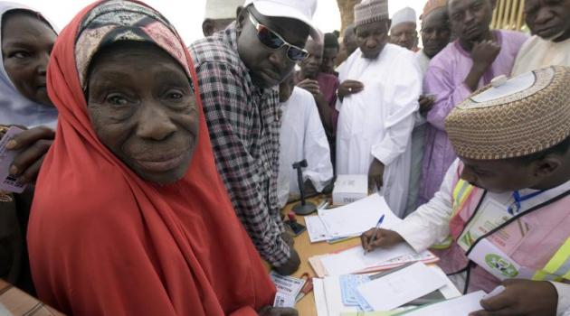 An elderly woman waits in line to vote at a polling station in Daura, Katsina State, during presidential elections on March 28, 2015/AFP