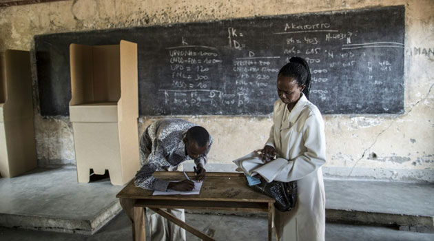 Electoral commission officials register at a polling station in Cibitoke, Bujumbura, on June 28, 2015/AFP