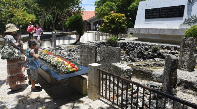 People pray in front of the Himeyuri Monument for those killed in the battle for Okinawa during World War II at the Himeyuri Peace Museum in Itoman, Okinawa prefecture, on June 19, 2015 © AFP/File