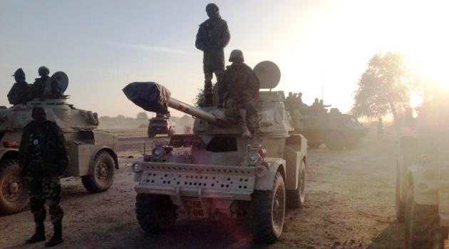 Soldiers of the Chadian army stand next to Panhard AML 90 armoured vehicles on January 21, 2015, at the border between Nigeria and Cameroon, some 40 km from Maltam, as part of a military contingent against the armed Islamist group Boko Haram/AFP  