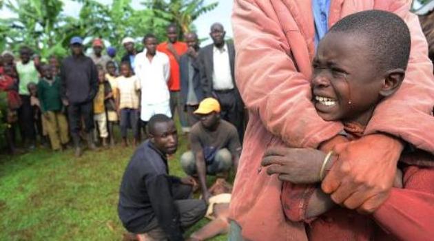 A boy cries before being circumcised in Shinyalu, in Kakamega, on August 8, 2014/AFP