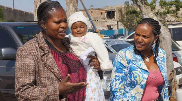 Baby Bhakita, her mother and Capital FM News Judie Kaberia at the JKIA. Photo/ FRANCIS MBATHA