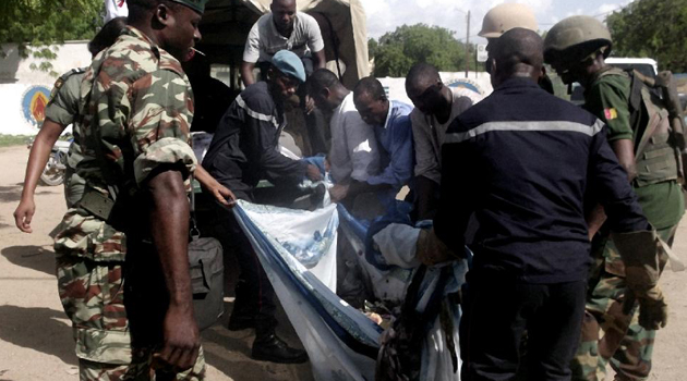 Some of the injured being carried into a van/AFP