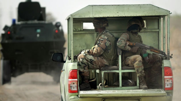 Nigerian soldiers patrol in the north of Borno state close to a former camp of Boko Haram on June 5, 2013 near Maiduguri/FILE