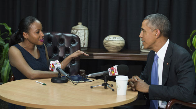  US President Barack Obama (R) speaks with Olive Burrows, producer at Kenya's Capital FM, during a radio interview in Nairobi on July 26, 2015/AFP