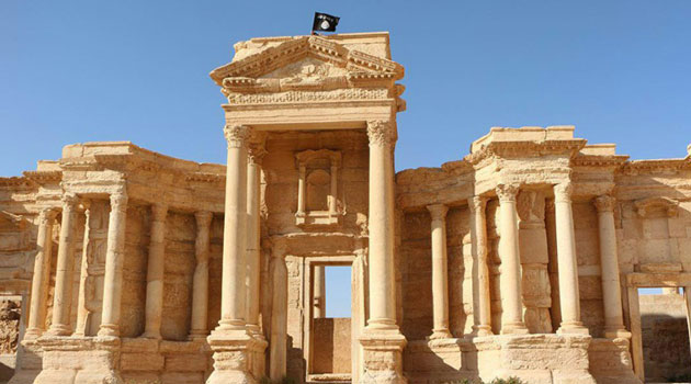 Image made available by Jihadist media outlet Welayat Homs allegedly shows a flag of the Islamic State group fluttering above the Roman theatre in Palmyra/AFP