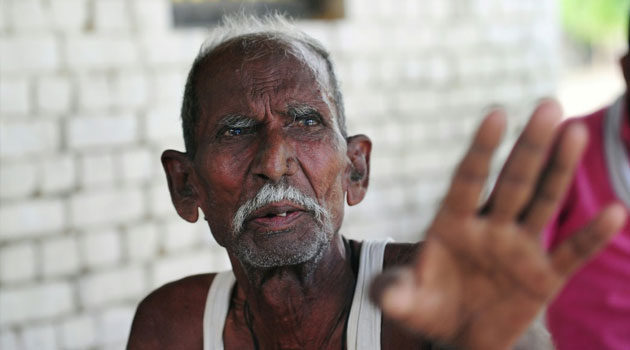 Indian farmer Ramjanam Mauriya, who is struggling to prove to authorities that he is still alive after being declared dead by his younger brother, at home in Uttar Pradesh/AFP