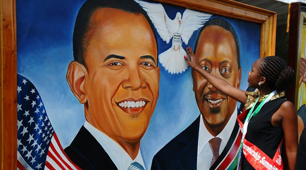 A Kenyan woman touches a painting depicting a dove between US President Barack Obama and Kenyan President Uhuru Kenyatta at Kenyatta International Convention Centre (KICC) in Nairobi on July 22, 2015/AFP