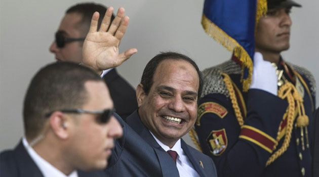 Egyptian President Abdel Fattah al-Sisi waves as he arrives for the opening ceremony of a new waterway at the Suez Canal on August 6, 2015, in the port city of Ismailiya/AFP