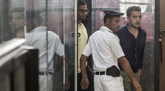 Al-Jazeera journalist Egyptian Baher Mohamed (R) attends his trial at the Torah prison in Cairo on August 2, 2015/AFP