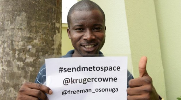 Space enthusiast Freeman Osonuga holds a campaign flyer to solicit support for his quest to be selected to be the first black African in space in Lagos on August 21, 2015/AFP