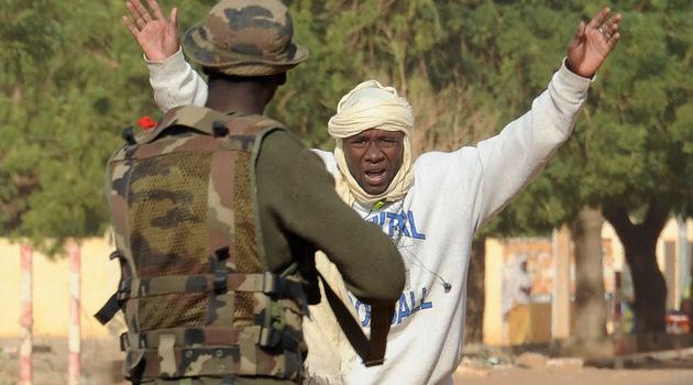 A man surrenders to a police officer/AFP