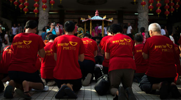 Most of the passengers aboard the flight were Chinese, and around a dozen of their relatives gathered outside the Beijing offices of Malaysia Airlines, with emotions running high/AFP