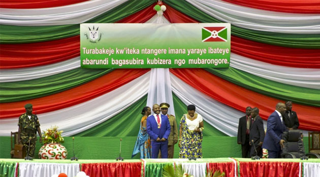 Burundi's President Pierre Nkurunziza (C) smiles after being sworn in for a controversial third term in power, at the Congress Palace in Kigobe district, Bujumbura on August 20, 2015/AFP