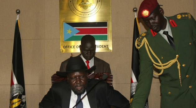 Top party official Pagan Amum and rebel chief Riek Machar signed a deal, but mediators said Amum was not representing the government. President Salva Kiir watched the signing, after briefly shaking hands with Machar/AFP