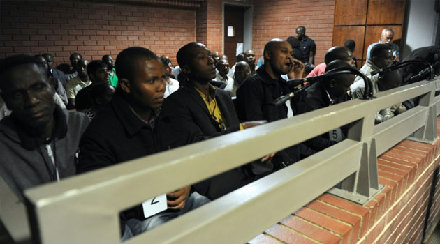 A picture taken on March 8, 2013 shows some of the South African police officers on trial in Benoni court over the death of Mido Macia, a Mozambican taxi driver who died in custody after being dragged behind a police van/AFP