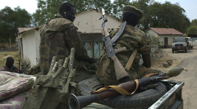 South Sudanese People Liberation Army (SPLA) soldiers sit on a pick up truck during a patrol in Malakal on January 21, 2014/AFP