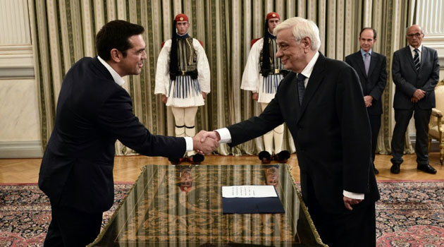 Greece's Syriza leader and newly elected Prime Minister Alexis Tsipras (L) is congratulated by President Prokopis Pavlopoulos after the oath-taking ceremony, in Athens on September 21, 2015  © AFP