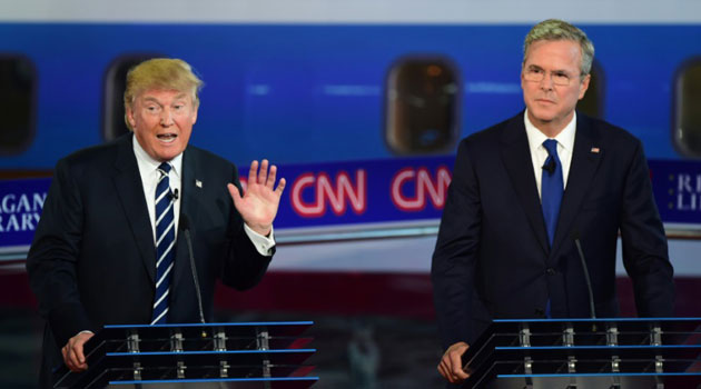 Republican presidential hopeful Donald Trump (L) gestures as Jeb Bush looks on during the Republican Presidential Debate at the Ronald Reagan Presidential Library in Simi Valley, California/AFP